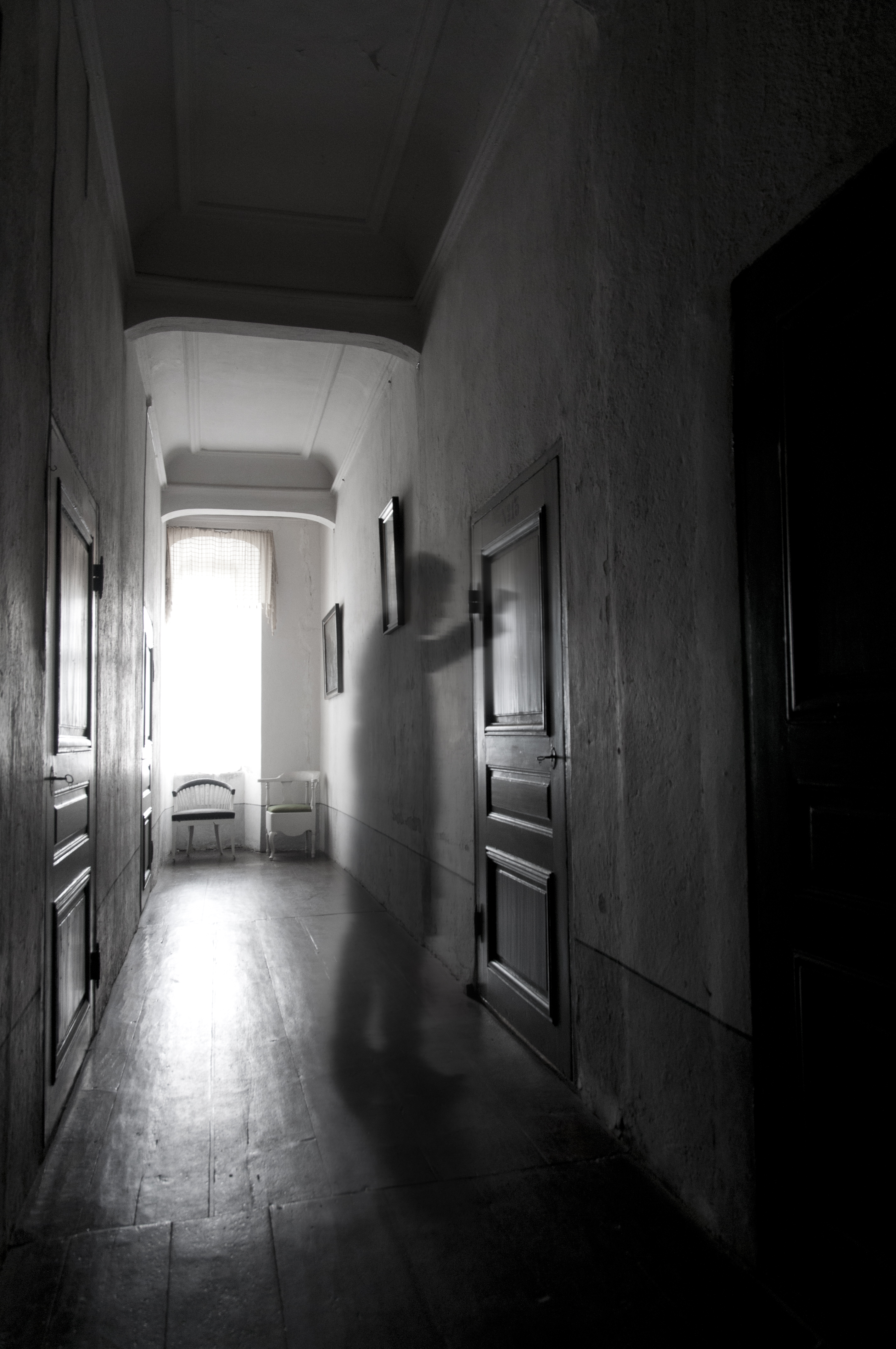 En genomskinlig figur står i korridoren utanför spökrum nummer 13 och knackar på dörren.