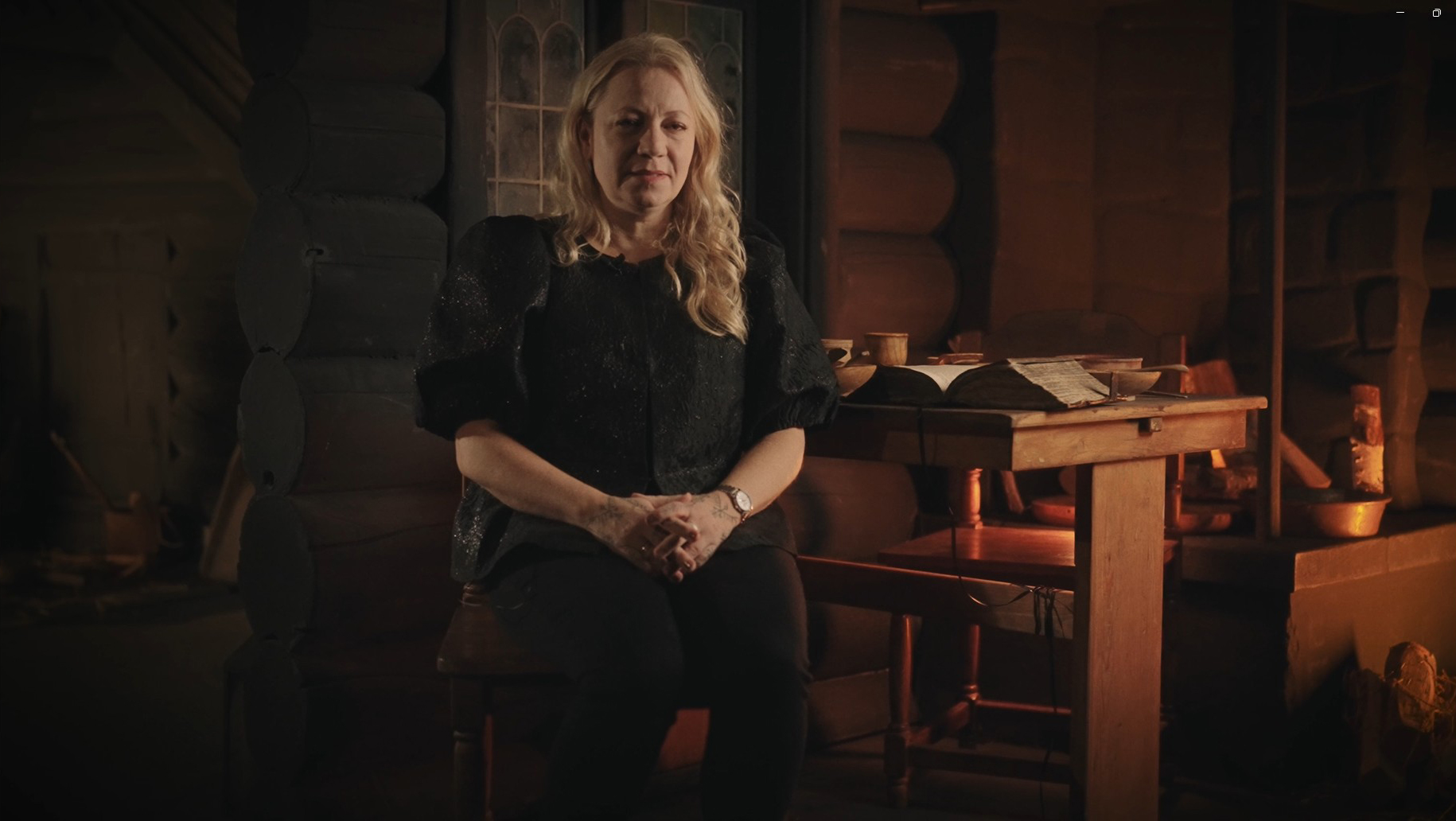 Skärmklipp ur film där museipedagog Mikaela Radakovic Kjäll berättar om Lusse i Svarttorps öde under häxprocessen i Finspång. Filmen är inspelad i utställningen HÄXOR.